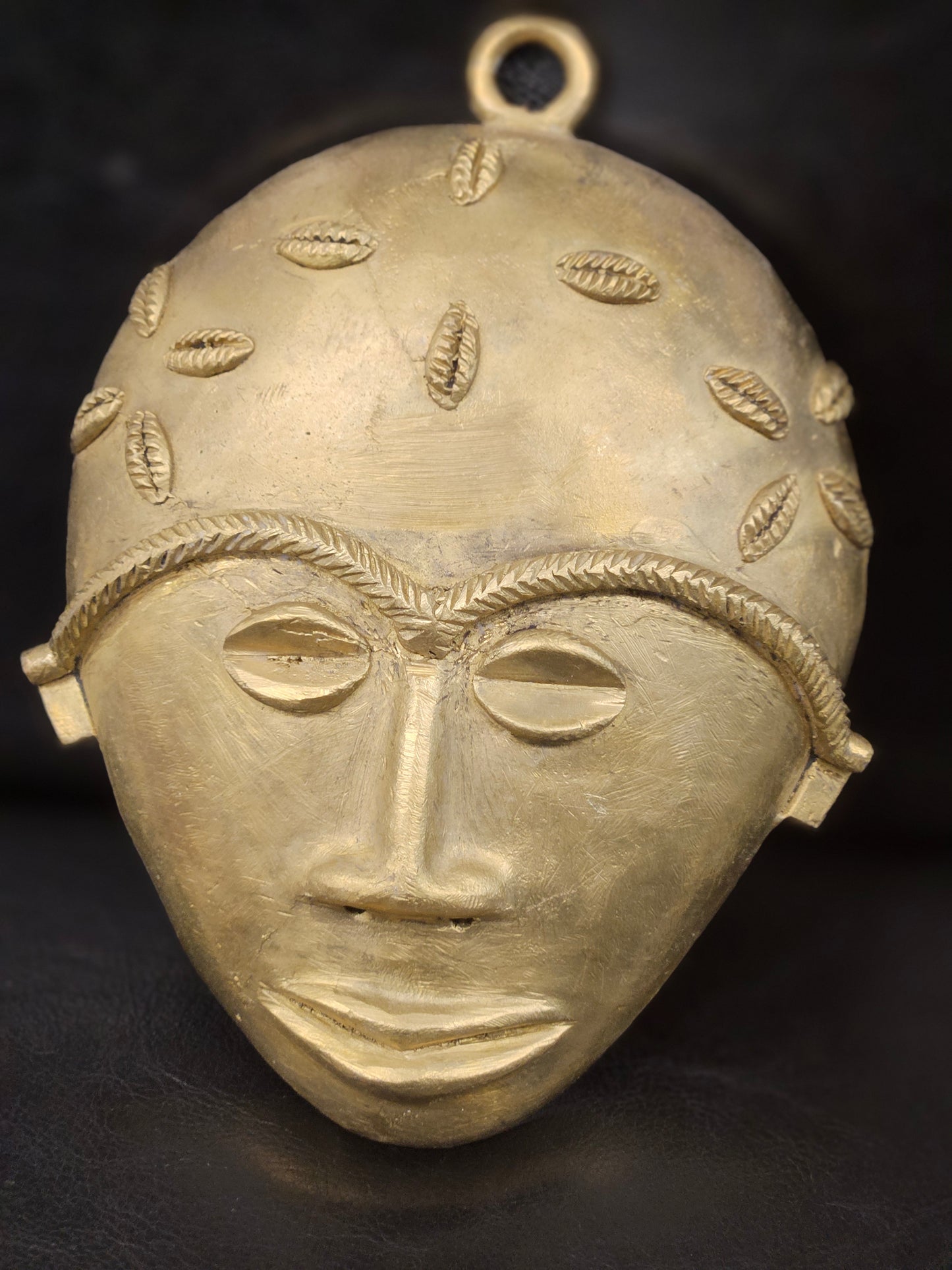 XL brass African wall sculpture decorated with symbolic cowrie carvings, representing traditional Ashanti cultural artistry.