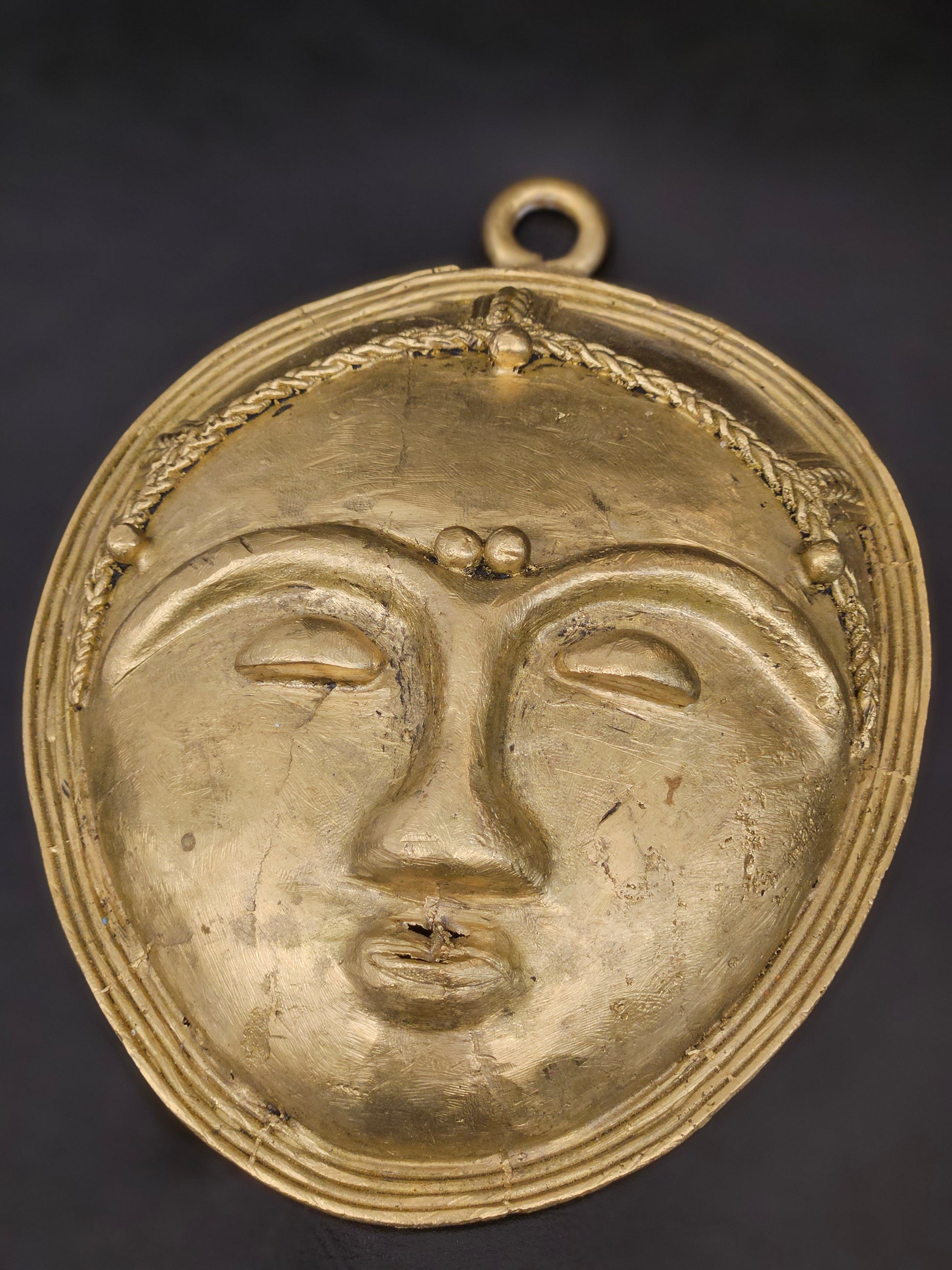 Handmade African mask with polished brass finish, ideal for Afrocentric home decor