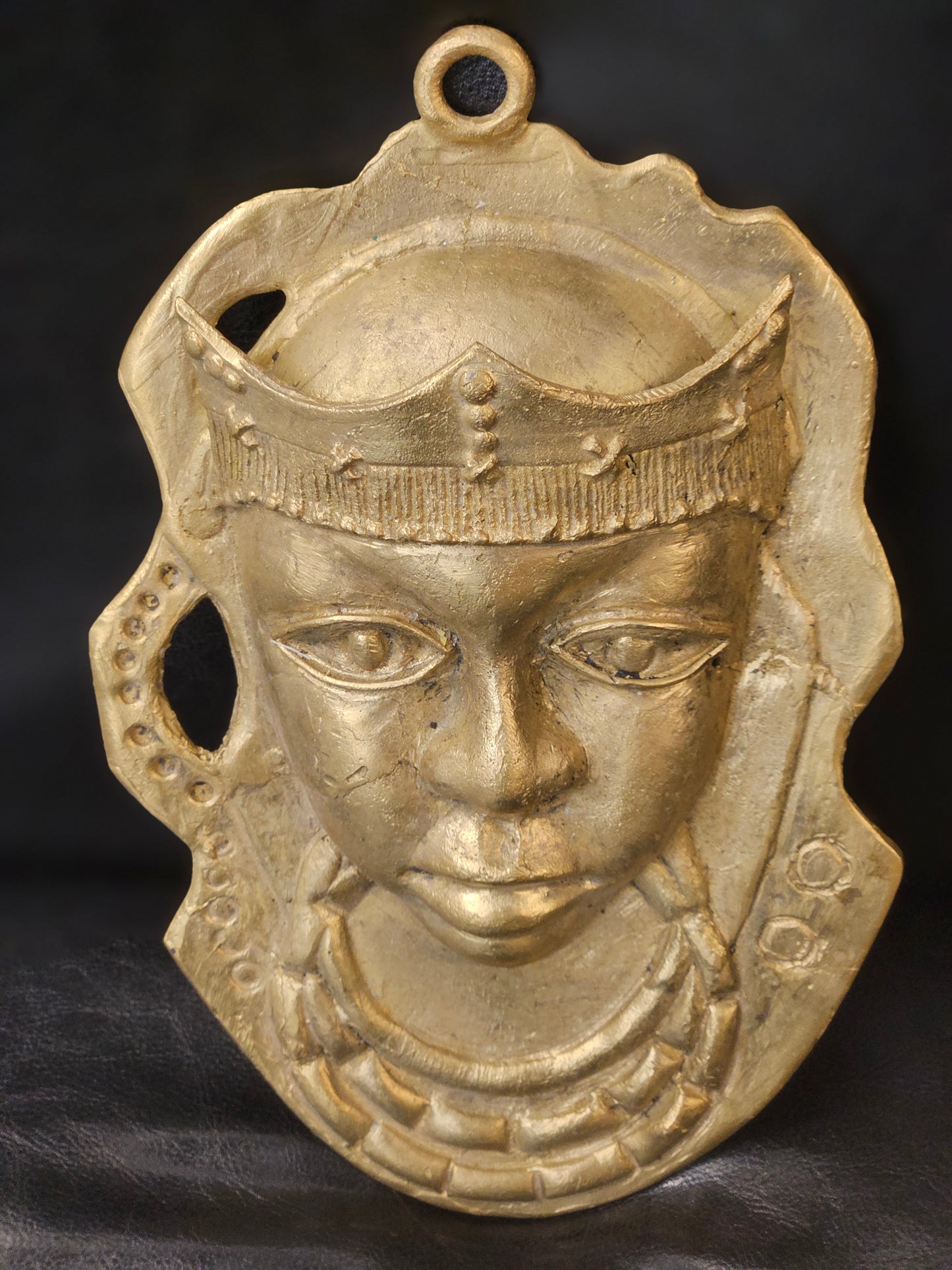 Handcrafted Ashanti brass mask from Ghana measuring 6 x 8.5 inches, featuring royal headpiece and intricate facial details in antique gold finish