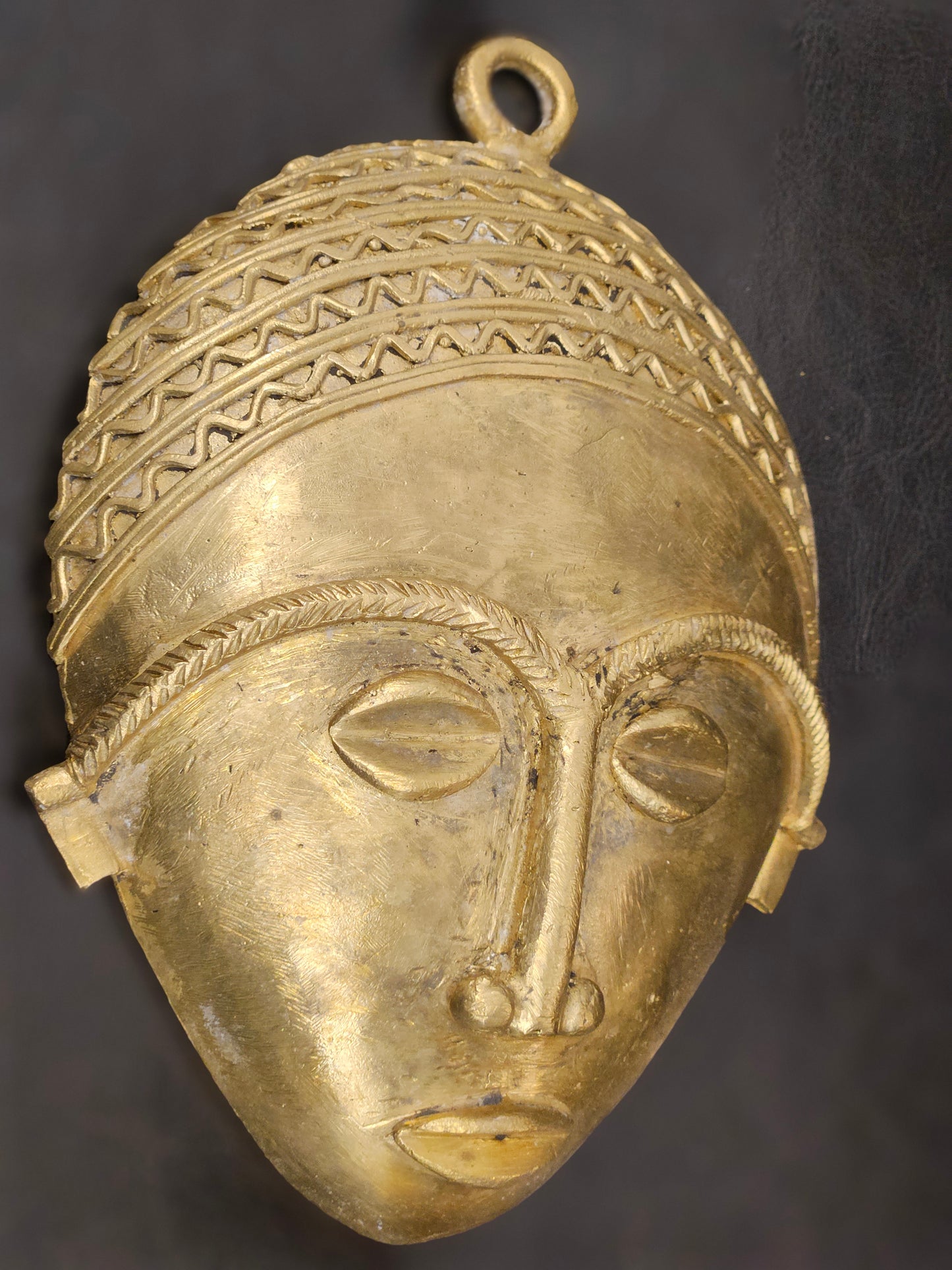Side profile of handcrafted African brass wall mask, made in the Ashanti Region of Ghana, ideal for boho wall art
