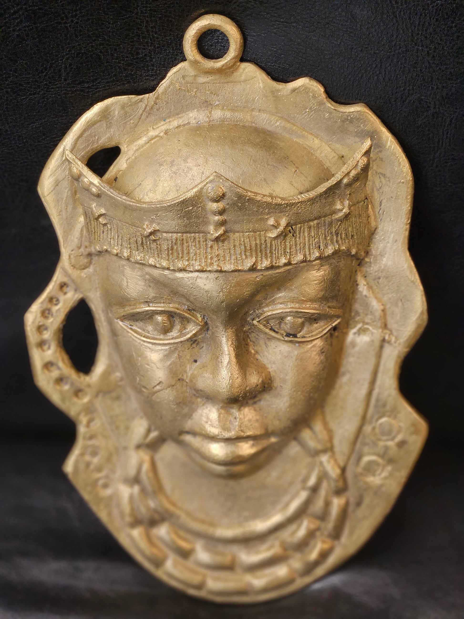 Handcrafted Ashanti brass mask from Ghana measuring 6 x 8.5 inches, featuring royal headpiece and intricate facial details in antique gold finish
